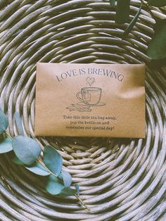 a brown paper bag sitting on top of a wicker basket next to green leaves