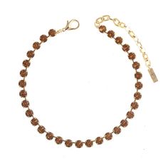 a gold bracelet with brown beads and a clasp on an adjustable chain, set against a white background