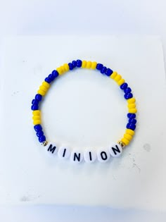 a yellow and blue beaded bracelet with the word'minion'written on it