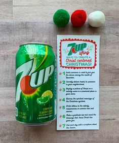 a can of 7up next to some pom - poms on a table