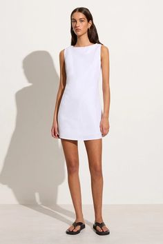 In responsibly sourced European Flax® linen, the Lui Mini Dress in White is a modern take on the classic summer mini. It features a high boat neckline, relaxed A-line silhouette and back waist ties with a twist detail to cinch as desired. Lined throughout for extra coverage. Summer Wardrobe Staples, Designer Clothing Brands, White Linen Dresses, Mini Dress White, Maxi Dress Sale, Linen Mini Dress, Grad Dresses, Faithfull The Brand, Sleeveless Mini Dress