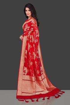 Beautiful red Benarasi georgette saree for weddings and festive occasions. The saree is enhanced with floral zari jaal work throughout. It comes with a matching blouse piece. Buy online from Pure elegance. Disclaimer: The shown stitched blouse on the model is for display purpose only. The saree comes with a matching blouse piece and finished with fall and piko. The actual product may vary slightly from the image. These are custom orders, hence expect slight variation in color, placement of the m Red Pre-draped Saree With Sheer Dupatta For Eid, Festive Red Pre-draped Saree With Pallu, Red Pre-draped Saree For Festive Designer Wear, Red Pre-draped Saree For Designer Wear And Festive Season, Red Pre-draped Saree With Resham Embroidery For Puja, Red Semi-stitched Pre-draped Saree For Wedding, Red Pre-draped Dola Silk Saree With Sheer Dupatta, Festive Red Blouse Piece With Sheer Dupatta, Semi-stitched Red Pre-draped Saree For Wedding