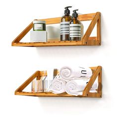 two wooden shelves with towels and soaps on them