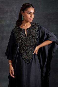 Black kaftan, highlighted with tonal embellished yoke. Paired with a pant.
Components: 2
Pattern: Embellished
Type Of Work:  Beads, Crystals
Neckline: Notched Neck
Sleeve Type: Three Quarter Sleeves
Fabric: Habutai Silk, Chantilly Lace
Color: Black
Other Details: 
Model height: 5ft 8inches, wearing size M

Occasion: Sangeet - Aza Fashions Hand Embellished Evening Sets For Eid, Embellished Evening Kaftan With Cape Sleeves, Evening Kaftan With Cape Sleeves For Eid, Festive Silk Kaftan With Sequins, Festive Designer Kaftan With Sequins, Designer Sequined Kaftan For Eid, Elegant Embellished Kaftan With Cape Sleeves, Eid Party Hand Embellished Kaftan, Elegant Hand Embellished Kaftan With Cape Sleeves