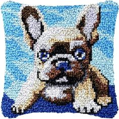 a beaded pillow with a dog on it's face and blue sky in the background