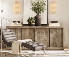 a living room scene with focus on the chaise lounge chair and large framed pictures