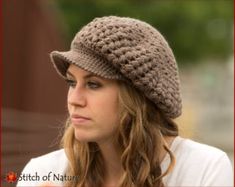 a young woman wearing a crocheted hat looks off to the side while standing outside