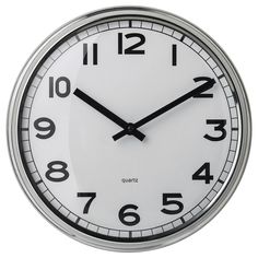 a white clock with black hands and numbers on the face is shown against a white background