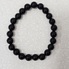 Black Obsidian Bracelet 8 Mm Beads..Black Obsidian Is Believed To Be A Stone Of Clarity, With The Ability To Release Emotional, Physical, And Spiritual Blockages, Drawing Out Stress And Tension. Obsidian Is Also Known For Clearing Ancient Traumas, Detoxification, And Encouraging Personal Growth. Elegant Black Stretch Bracelet With Gemstone Beads, Elegant Black Crystal Bracelet, Black Onyx Crystal Bracelet With 8mm Beads, Black Obsidian Round Beads Crystal Bracelet, Black Obsidian Round Crystal Bracelet, Black Onyx Round Crystal Bracelet, Black Obsidian Stretch Bracelet With Round Beads, Black Crystal Bracelet With Gemstone Beads, Black Beaded Crystal Bracelet