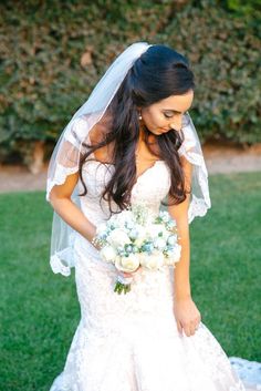 a woman in a wedding dress holding a bouquet