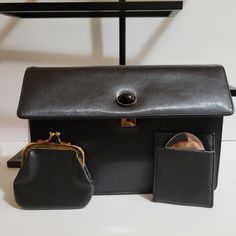 Vintage Koret Black Calf Skin Leather Feel And Looks Like Silk. Black Cabochon Snap Closure. Comes With The Original Chain Attached Coin Purse And Original Mirror In Pouch. In Amazing Condition. Has A Few Minor Scuffs From Storage. Looks Like It Was Never Used. Please See Pictures For Description And Condition Measures Approx: 5" X 1.5" X 8" Luxury Vintage Clutch Coin Purse, Black Office Clutch With Magnetic Closure, Classic Black Clutch For Office, Timeless Black Travel Clutch, Elegant Vintage Black Bag For Formal Occasions, Elegant Vintage Black Formal Bag, Luxury Black Clutch For Workwear, Luxury Black Clutch For Work, Timeless Black Clutch For Office