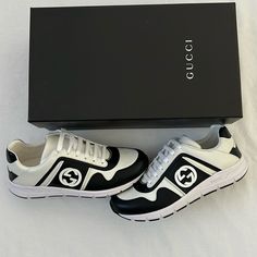 Adorned With Signature Details, These Gucci Sneakers In Leather Are Designed In A Low-Cut Style. They Have Lace-Up Vamps, A Gg Logo On The Sides, And Flexible Rubber Soles. The Monochrome Look Ensures They Are Easily Coordinated With Your Casuals. Size Mens 4 1/2 Fits Women’s Size 7.5 - 8 New In Box Gucci Black Sneakers With Contrast Sole, Gucci Sneakers With Logo Detail For Sports, Gucci Black Sneakers With Logo Print, Black Gucci Sneakers With Logo Print, White Gucci Sneakers With Logo, Gucci White Sneakers For Streetwear, Sporty Gucci Sneakers With Logo Detail, Designer White Sneakers With Logo, White Gucci Sneakers For Streetwear