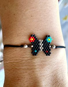 a person wearing a bracelet with beads on it