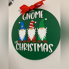 a green christmas ornament with three gnomes and the words gnome for christmas