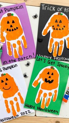 three handprinted halloween cards with pumpkins on them