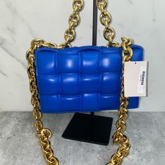 Padded Intrecciato Leather Crossbody Bag One Interior Zipped Pocket Metal Closure Material: 100% Lambskin Lining: Bonded Lambskin Color: Cobalt (Blue) Hardware: Gold Finish Height: 18 Cm | 7.1" Width: 26 Cm | 10.2" Depth: 8 Cm | 3.1" Handle Drop: 13 Cm | 5.1" Strap Drop: 50 Cm | 19.7" Made In: Italy Product Code: 631421vbwz08425 Comes With Dust Bag No Box Never Carried Never Used! Comes From A Smoke Free Pet Free Environment Designer Rectangular Shoulder Bag With Chain Strap, Luxury Crossbody Shoulder Bag With Gold Chain, Luxury Rectangular Bag With Gold Chain, Luxury Rectangular Bags With Gold Chain, Luxury Blue Bag With Chain Detail, Luxury Blue Bags With Chain Detail, Luxury Blue Bags With Chain, Luxury Shoulder Bag With Chain For Shopping, Luxury Blue Chain Bags