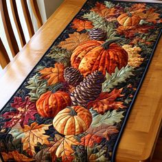 a table runner with autumn leaves and acorns on it