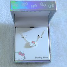 Brand New In Box Hello Kitty Pendant Necklace Excellent Condition With No Flaws 925 Sterling Silver Chain Length Approx 16" With 2" Extender Pendant Height Approx 3/8" Pendant Width (Includes Her Whiskers) Approx 7/16" A White Enamel Hello Kitty Head With Silver Detail And A Pink Bow On Her Left Ear; Silver Link Chain Runs Through The Pendant (Opposed To The Pendant Hanging From A Bale) Making It A Slider Pendant, Opposed To Being Stationary Fun Facts: Hello Kitty Was Born On 11/01/74 In The Out Hello Kitty Adjustable Jewelry For Gifts, Adjustable Hello Kitty Jewelry As Gift, Adjustable Hello Kitty Jewelry Gift, White Sterling Silver Hello Kitty Jewelry, White Hello Kitty Necklace For Gift, Hello Kitty White Necklace For Gift, White Hello Kitty Necklace Gift, Adjustable White Jewelry With Cat Design, Adjustable White Cat Design Jewelry