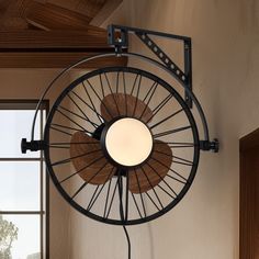 a fan mounted to the side of a wall next to a window in a room