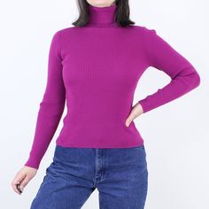 Item Description  This is a super cute 90s ribbed turtleneck top in a fun and bright magenta color. I love the long sleeves, comfy material (that feels to me like cotton), and the flattering fit of the rib knit design. This is such a great versatile piece to have in your wardrobe, and it is in great vintage condition!  Item Specifics  Brand - Unknown (missing tag) Material - Feels like cotton Color - Magenta Measurements  Shoulder to Hem - 22.5 in.  Sleeve Length - 23.5 in.  Sleeve Opening - 2.75 in. (5.5) Bust - 13.5-16 in. (27-32) Policies and More Information Please read my terms and conditions before purchasing; I do not accept returns based on fit of the item.  See my FAQs below to see how I measure my items (The Sizing Info and the Measurement Key FAQs).  Please use these measurement Ribbed Fitted Winter Top, Ribbed Fitted Top For Winter, Trendy Solid Stretch Turtleneck, Trendy Fitted Turtleneck For Spring, Trendy Ribbed Funnel Neck Sweater, Trendy Turtleneck Sweater For Spring, Winter Purple Fitted Tops, Fitted Purple Winter Tops, Fitted Purple Tops For Winter