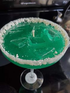 a green and white drink sitting on top of a table