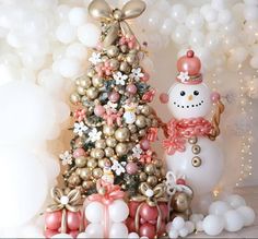 a snowman and christmas tree are in front of balloons that look like they have been decorated