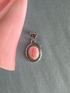 Beautiful Southwestern pendant with genuine Pink Conch Shell stones set on 925 sterling silver. It is stamped sterling and signed Zia. The pendant measures 1-3/8" long (includes bail) and 3/4" wide. The bail fits up to 7mm. Please allow slight variations in stones as item received may not be exact one used in photo. More photos available upon request. You will receive the item in a gift box. Thanks for looking and check out more items in my Etsy shop for more great items and deals! https://www.e Pink Conch Jewelry, Southwestern Style Oval Cabochon Jewelry Gift, Sterling Silver Oval Cabochon Jewelry Stamped 925, Sterling Silver Jewelry Stamped 925, Oval Cabochon, Sterling Silver Cabochon Rectangular Pendant, Sterling Silver Cabochon Rectangular Pendant Jewelry, Sterling Silver Jewelry With Cabochon Rectangular Pendant, Southwestern Sterling Silver Round Pendant Jewelry, Southwestern Sterling Silver Jewelry With Round Pendant