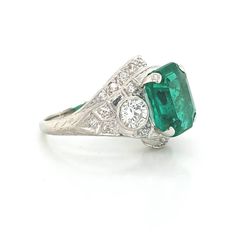 Gorgeous Vintage Diamond & Emerald in Platinum ring circ 1920's center set natural Colombia emerald weight 4.43ct size 11.1x9.3mm GIA cert. Has a nice rich green color ,brilliant clean very lively stones. Side Set two Natural old mine cut Diamonds Weight 0.50ct. Size 4mm SI1 -G lively brilliant, clean white bright stones. Side set small diamonds weight 0.25ct. Ring size 7.5 Resizable This tremendous old vintage ring is in a very good condition. Retail value $18,500 net. Appraisal available Vintage Emerald Ring With Vvs Clarity, Vintage Emerald Jewelry With Vvs Clarity, Art Deco Emerald And Diamond Ring For May Birthstone, Art Deco Round Cut Emerald Ring, Art Deco Green Platinum Jewelry, Gia Certified Art Deco Emerald Ring, Art Deco Diamond Ring For May Birthstone, Art Deco Emerald Ring In White Gold, Art Deco Green Emerald Ring With Diamond Accents