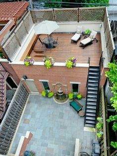 an overhead view of a patio with stairs and seating area in the middle of it