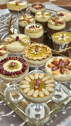 there are many desserts on the glass platter with different toppings in them