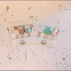 two packaged toothbrushes in the shape of sheeps on top of confetti sprinkles