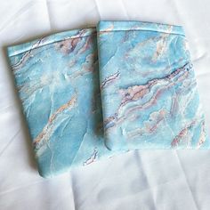 two pieces of blue marbled fabric on a white sheet