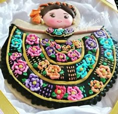 a decorated cake in the shape of a woman's dress with flowers on it