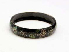 Vintage Cloisonne Enameled Bangle Bracelet-Black background with floral motif-Dark reds, pinks, and greens make up this fine enamel work-Interior circumference 8.2"-Width: .6"-Very good vintage condition, a little wear to the enamel on the inside edges, otherwise a very nice bangle Black Enamel Bangle Bracelet, Black Enamel Bracelet Jewelry, Black Enamel Bracelet Gift, Black Enamel Bracelets Gift, Black Enamel Bracelets For Gifts, Black Enamel Bracelets As Gift, Vintage Black Hand Painted Jewelry, Vintage Black Hand-painted Jewelry, Bracelet Flowers