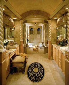 a large bathroom with two sinks and an oval rug on the floor in front of it