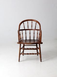 a wooden chair sitting on top of a white floor