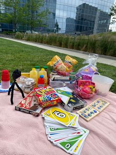 the table is covered with toys and snacks for kids to play in it's own yard