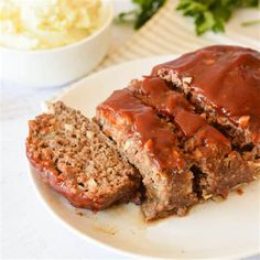 two slices of meatloaf on a white plate