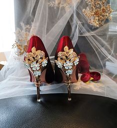 a pair of red high heeled shoes sitting on top of a table