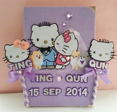 there are three hello kitty figurines sitting on top of a purple card holder