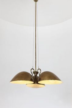 two lights hanging from a ceiling fixture in a room with white walls and flooring