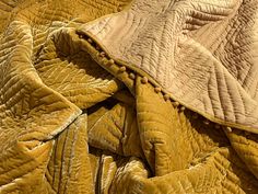 a close up view of a yellow quilt