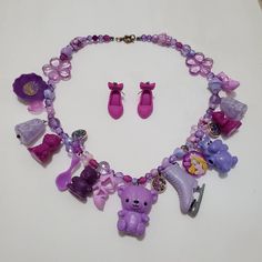 This is a purple themed charm necklace that I crafted out of vintage toys and charms. It is full of exciting variety and textures. Comes with matching earrings. Toy Necklace, Plastic Gift Wrap, Silly Goofy, Jewellery Sets, Lovely Necklace, Girly Jewelry, Crafts Ideas, Beaded Jewelry Diy, Jewelry Diy