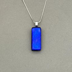 Cobalt Blue Dichroic fused glass Necklace. Handmade in West Yorkshire. Please note this listing is for the necklace only. Matching earrings available here; All pendants are handmade and unique, therefore patterns and colours may differ from the images shown. Dichroic glass has a transmitted colour and a completely different reflective colour; these two colours shift depending on the angle of view. This pendant has a Silver Plated glue on bail with the choice of different Sterling Silver or Silve Blue Necklaces With Rectangular Stone For Gift, Blue Necklace With Rectangular Stone For Gift, Minimalist Blue Necklace With Rectangular Pendant, Modern Blue Rectangular Necklace, Modern Rectangular Glass Jewelry, Blue Minimalist Rectangular Pendant Jewelry, Handmade Blue Rectangular Necklace, Blue Necklace With Large Rectangular Pendant, Blue Nickel Free Necklace With Recycled Glass