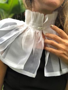 The hand made hand pleated detachable collar. Made of silk organza. Available colors - off white, black Finished with hand covered button. Total height of the collar- 25 сm, 10inch Sizing guide - collar length from closure to closure. Based on your neck circumference. I recommend to size up for this model. You can always provide your neck circumference to insure best fit. HOW TO MEASURE - measure your neck circumference about 1 inch above the neck base. Hand wash. Dry clean. Made to order 2 week Tie On Collar, Elegant Fitted Collars For Spring, White Doll Collar Blouse For Party, Spring Fitted Lace Collar, Elegant Summer Tops With Detachable Collar, White Detachable Fitted Collar, White Fitted Detachable Collar, Elegant Fitted Lace Collar, Fitted Blouse With Detachable Ruffled Collar