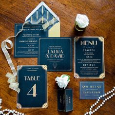 an assortment of wedding stationery items on a table