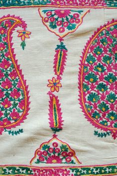 This is an antique Surat area embroidery from Gujarat, Indian in sumptuous green and pink dyed silk. The pink silk is cochineal and the green is from a combination of indigo and a yellow bearing plant. The design is in a beautiful boteh design filled with small flowers and framed by long serrated leaves forming a column between each boteh. It was probably made as a shawl with the boteh, or paisley, designs being on the end of the shawl or a hanging in and of itself with two pieces joined togethe Pink Silk Embroidered Fabric With Intricate Detail, Transitional Pink Dupatta With Floral Embroidery, Pink Bohemian Traditional Wear With Resham Embroidery, Transitional Pink Floral Embroidered Dupatta, Green Raw Silk Fabric With Floral Embroidery, Multicolor Floral Embroidered Raw Silk Fabric, Embroidered Pink Tussar Silk Traditional Wear, Pink Silk Thread Embroidered Fabric For Festivals, Green Floral Embroidered Raw Silk Fabric