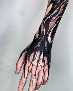 a hand with black and white ink on it