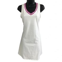 This Stunning Dress From Sincerely Jules Is Perfect For Any Active Occasion, From Tennis To Golf. The Dress Features A Flattering A-Line Style With A Sleeveless V-Neckline And Pink Trim. It Is Made From High-Quality Materials, Ensuring Durability And Comfort During Wear. The Dress Is Fully Lined And Comes In A Size Large With A Solid White Color And A Beautiful Pink Pattern. It Is Ideal For Women Who Love To Look Stylish While Staying Comfortable And Functional. The Dress Is Perfect For Any Occa White Stretch Lined Dress, Casual White Stretch Sleeveless Dress, White Stretch Lined Mini Dress, White Stretch Mini Dress Lined, White Stretch Mini Dress With Lining, White V-neck Sleeveless Dress For Spring, White Stretch V-neck Sleeveless Dress, Fitted V-neck Tennis Dress, White Stretch Sleeveless Beach Dress