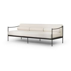 a white couch sitting on top of a metal frame